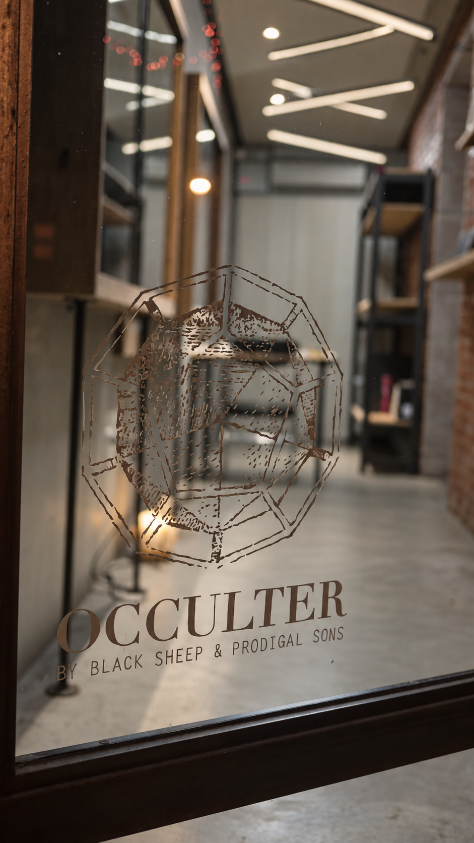 Occulter’s painted glass-door logo and store interior